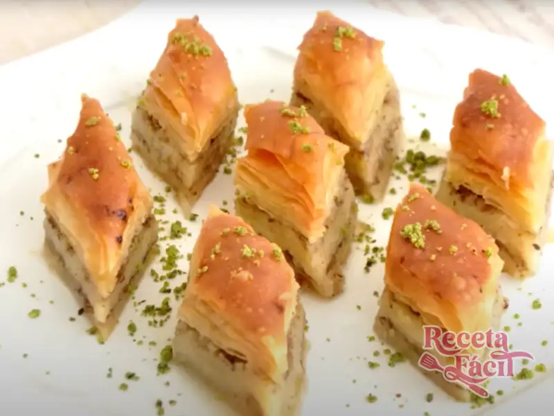 Baklava turco con almíbar y nueces en plato blanco